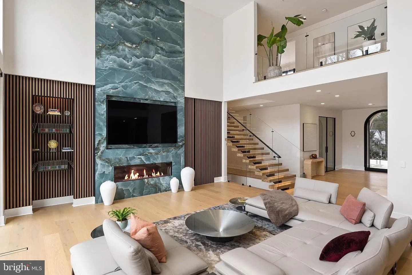 Bethesda Custom Modern Home living room with green stone fireplace wall in Bethesda, Maryland