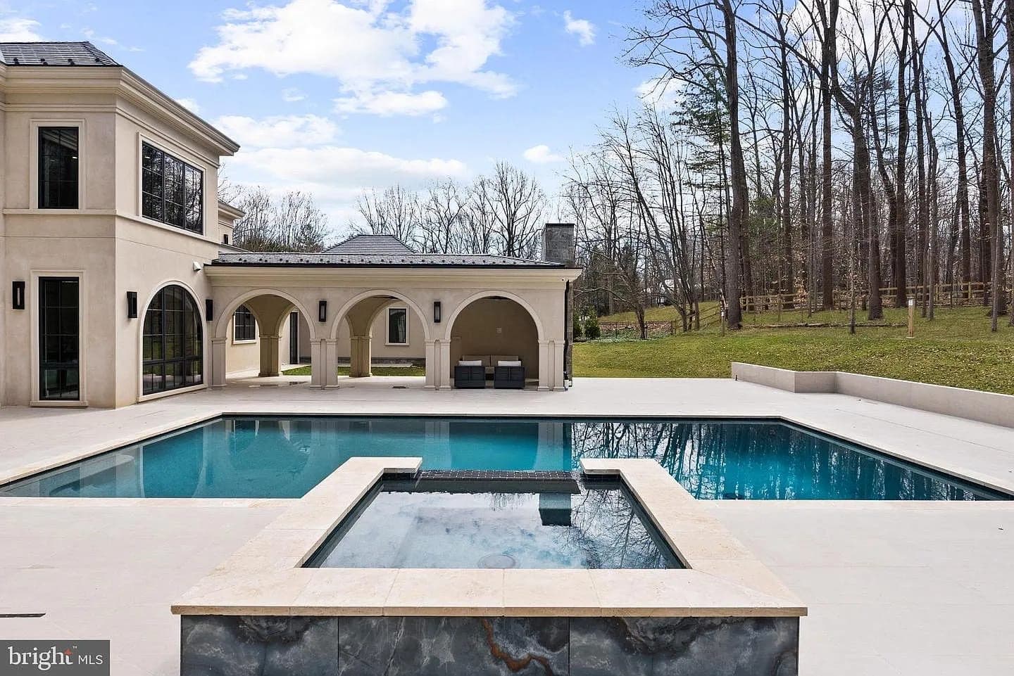 Rear exterior with pool, spa, and arched loggia at the Bethesda Custom Modern Home